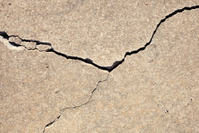A concrete pad in Aurora, IL with several cracks.