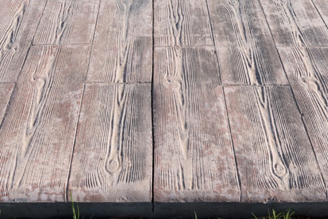 A close-up view of a wood slats stamped concrete design in Aurora, IL.